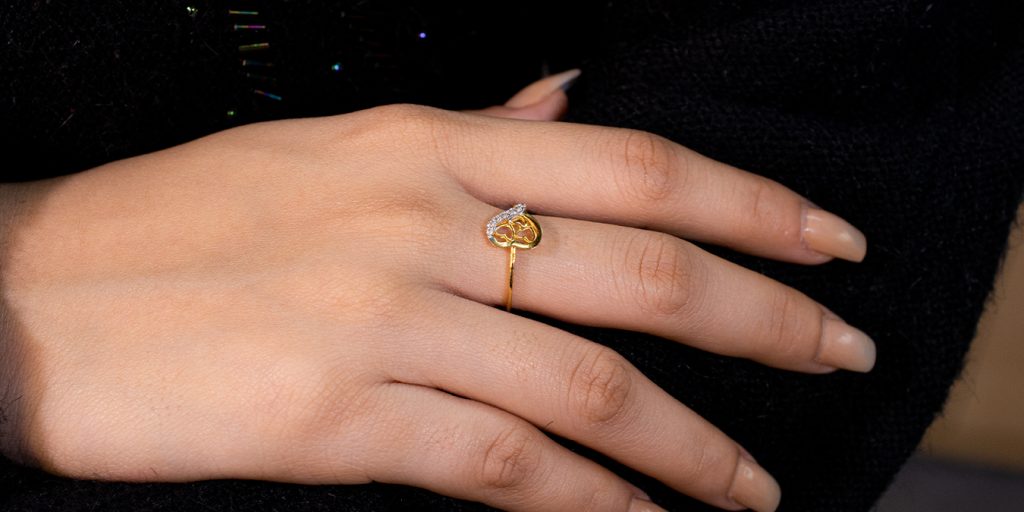 Engagement ring with a diamond on the elegant hand of a beautiful girl.  Stock Photo | Adobe Stock